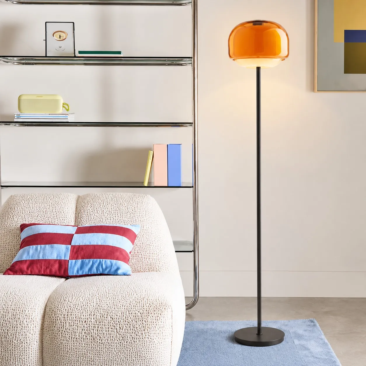 Orange floor lamp beside a sofa