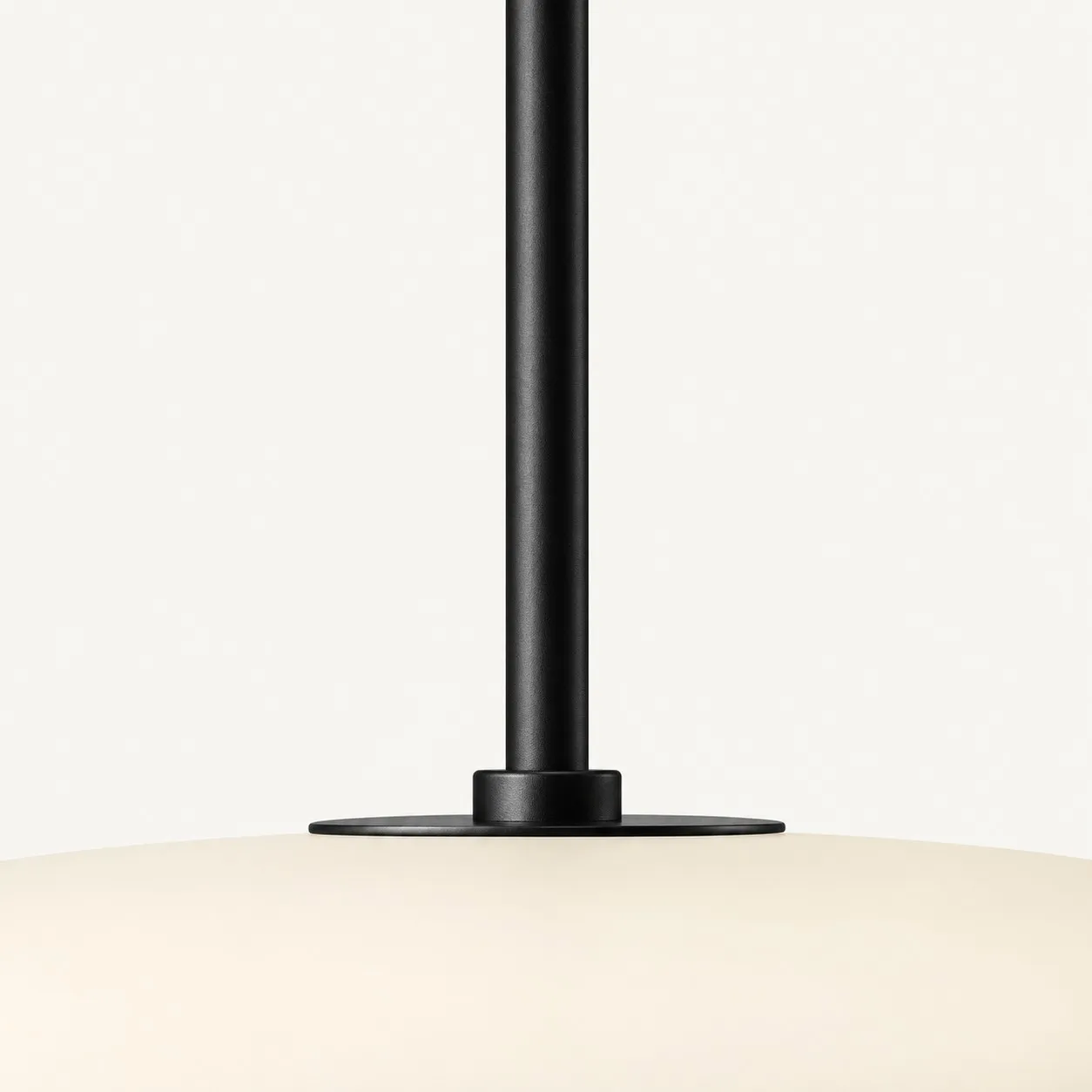 Black cord meeting the top of the cream shade