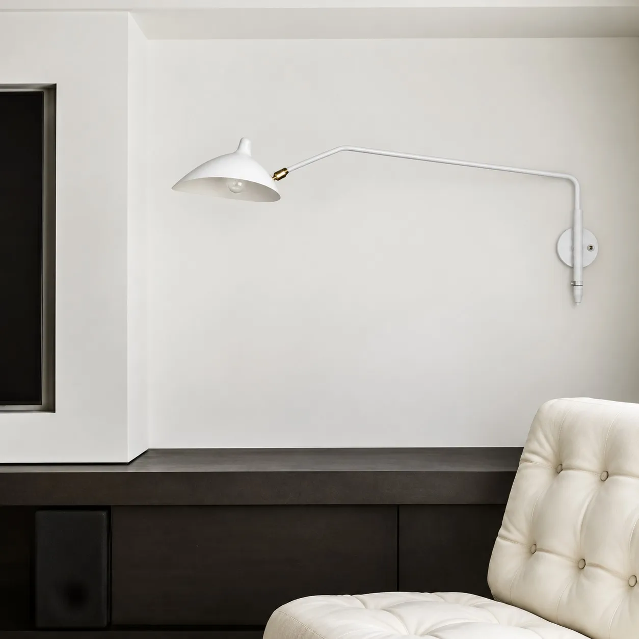 White one-light wall sconce above a bench