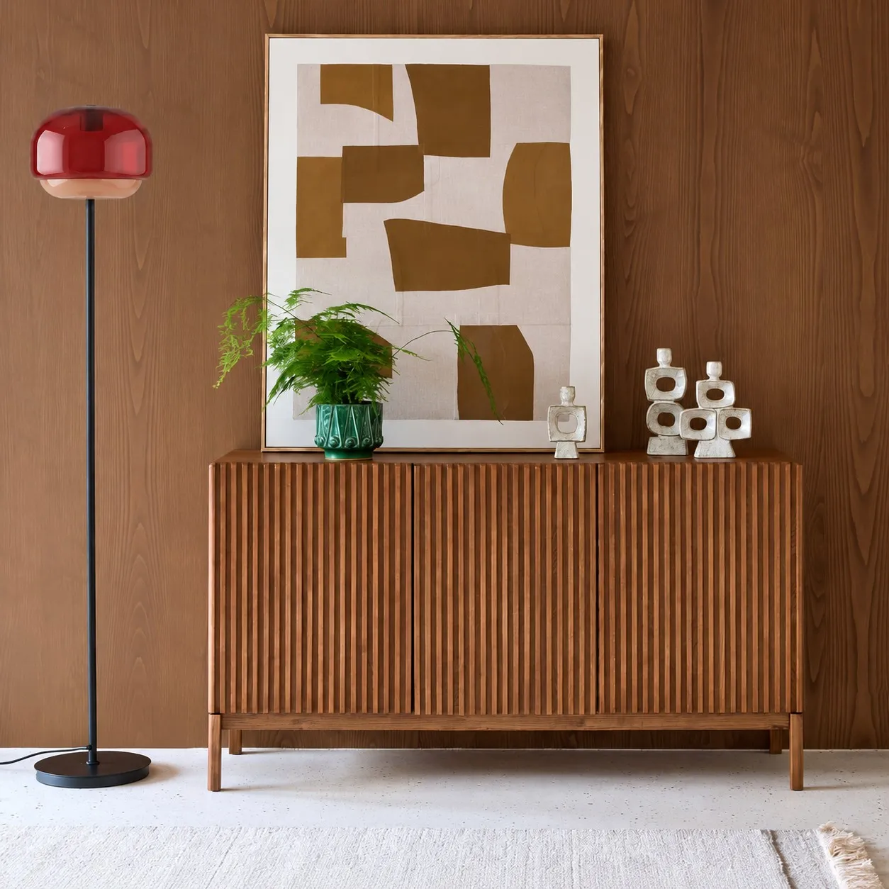 Burgundy floor lamp beside a sideboard
