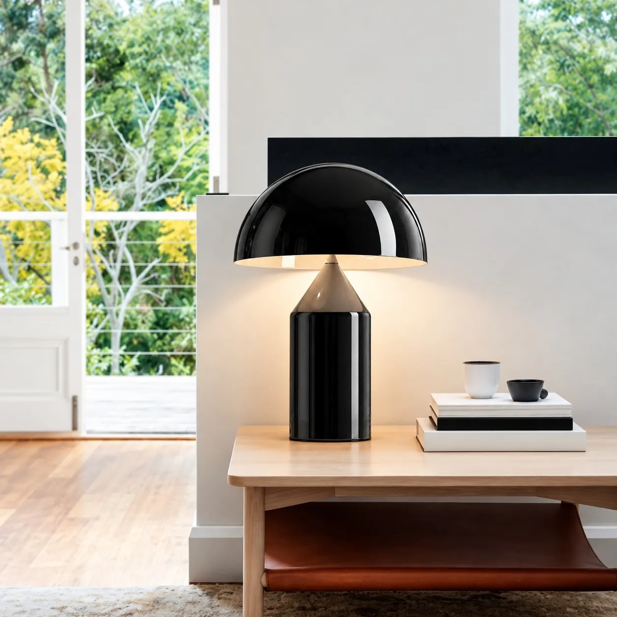Glossy black mushroom table lamp on a wood table