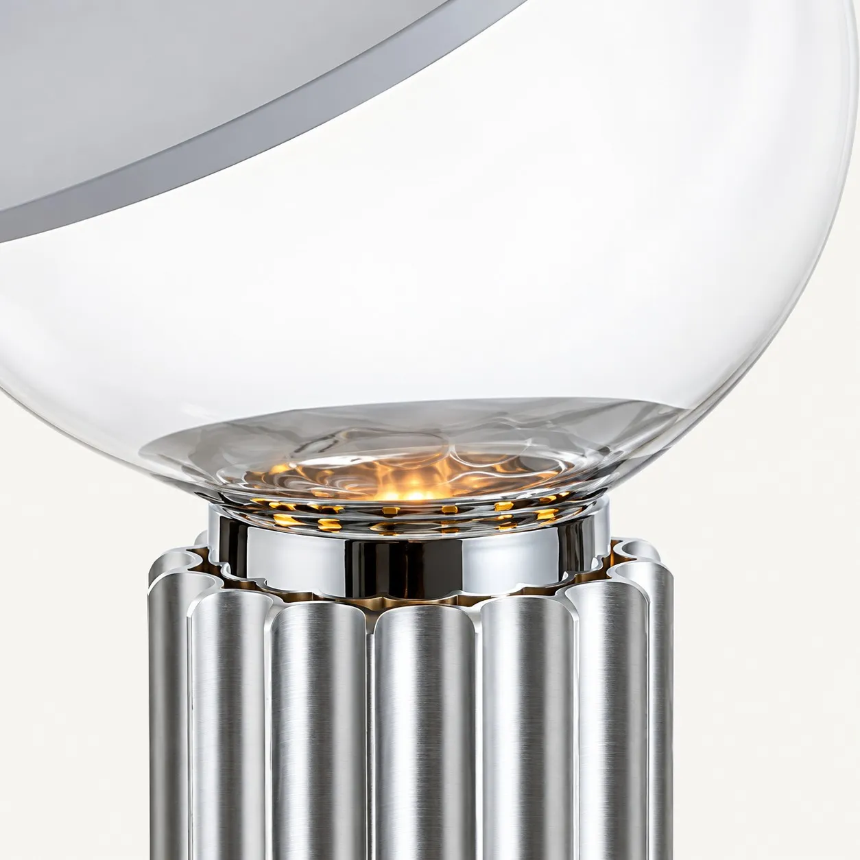 Clear glass bowl above a silver ribbed base