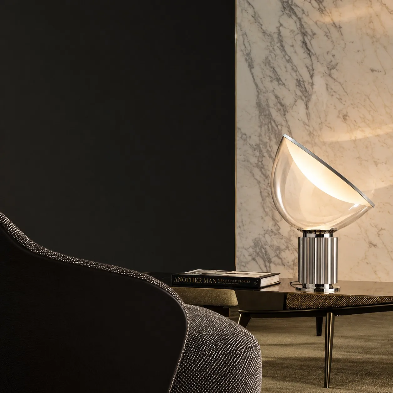 Silver glass bowl lamp on a table beside a chair
