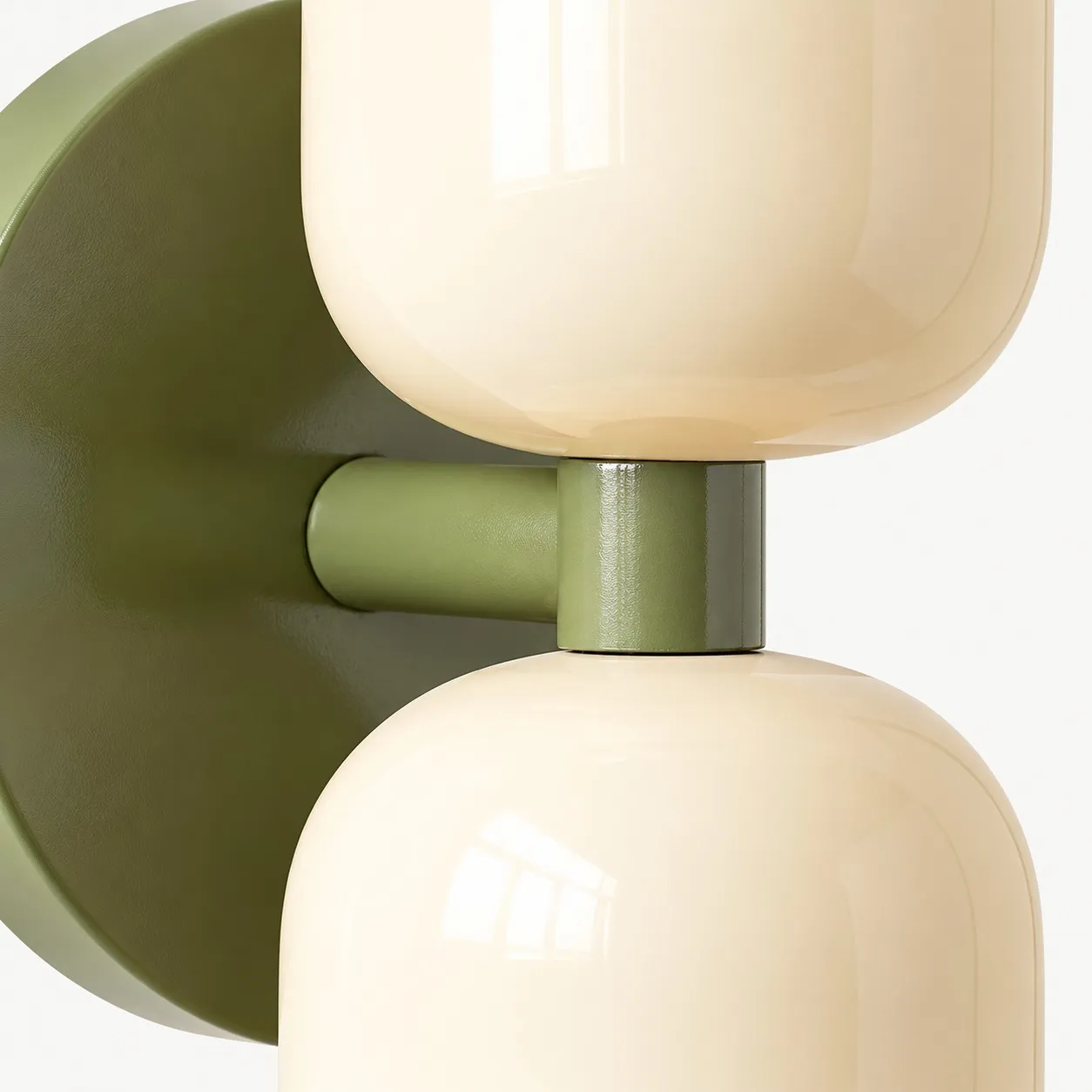 Close view of the white metal shade and green wall mount