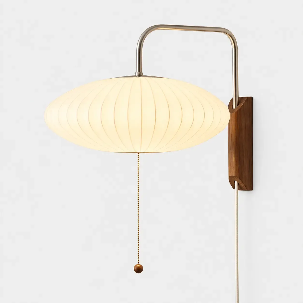Saucer ribbed wall sconce on a light background, shade lit