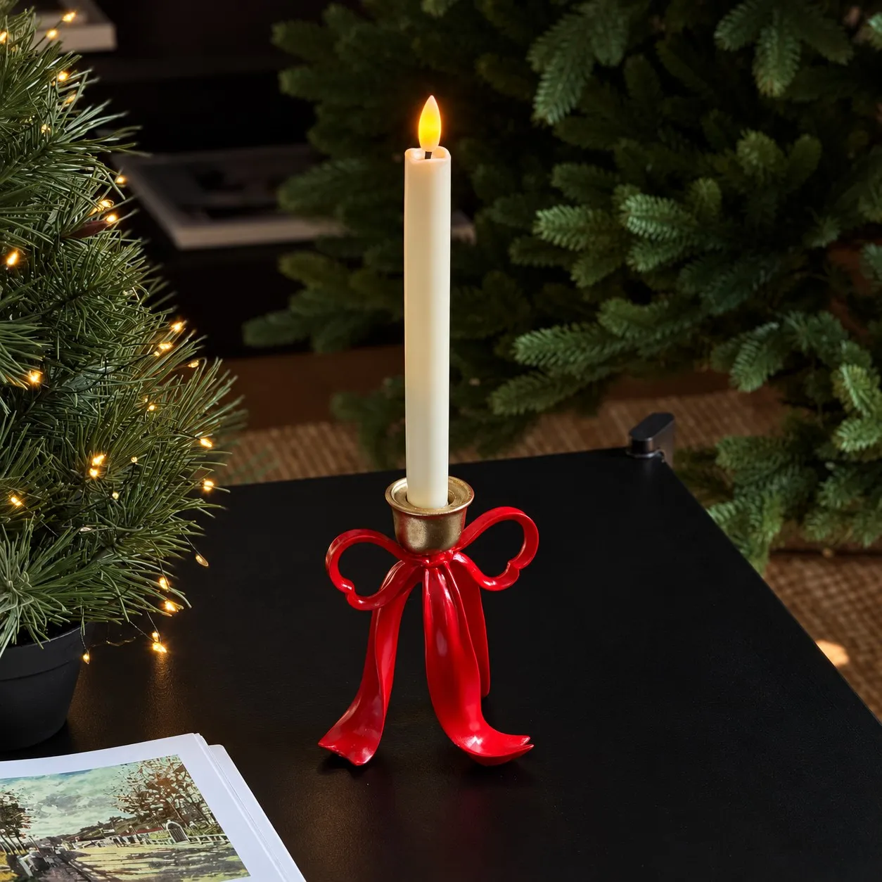 Red ribbon bow candle holder styled with a small pine tree