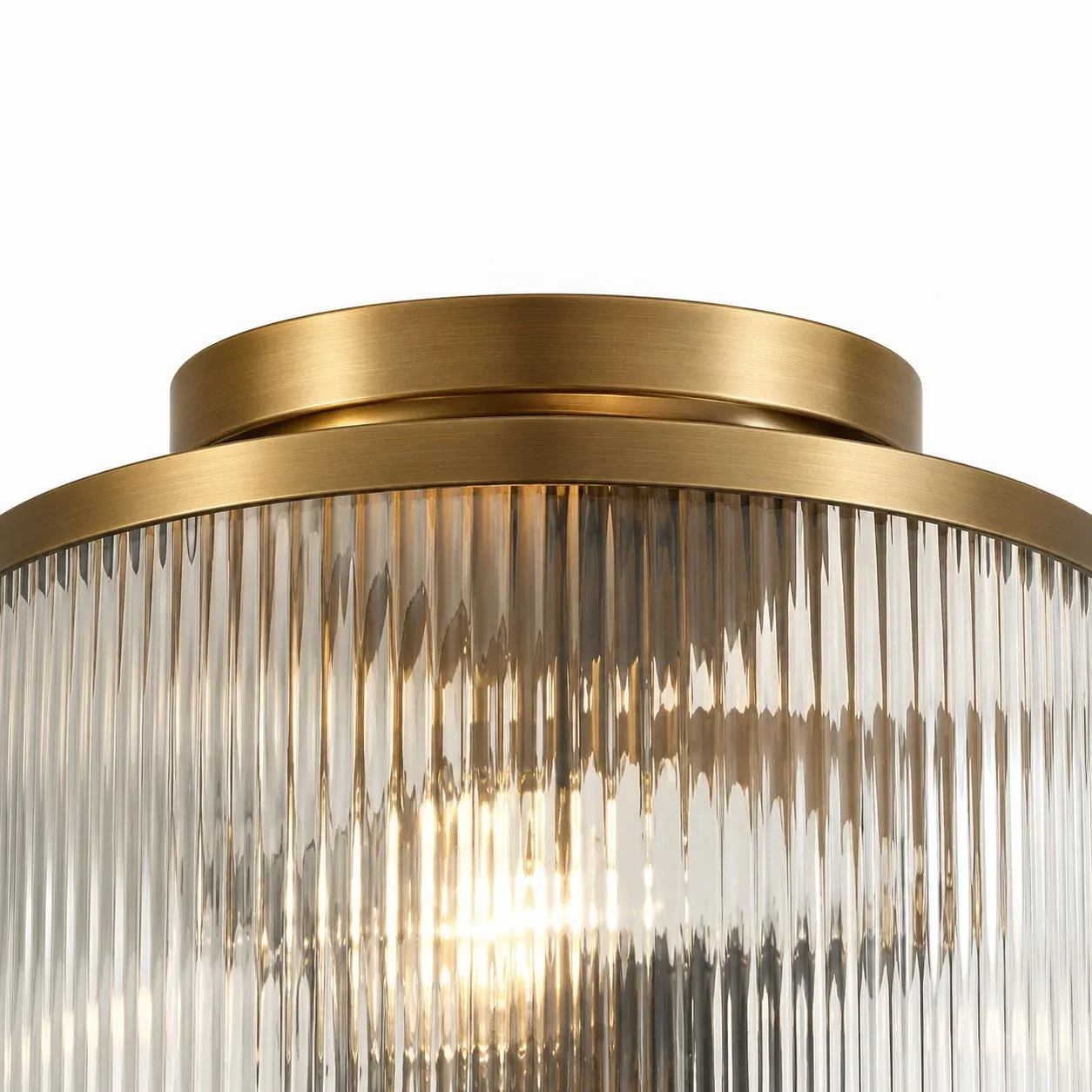 Brushed brass canopy and ring above clear ribbed glass