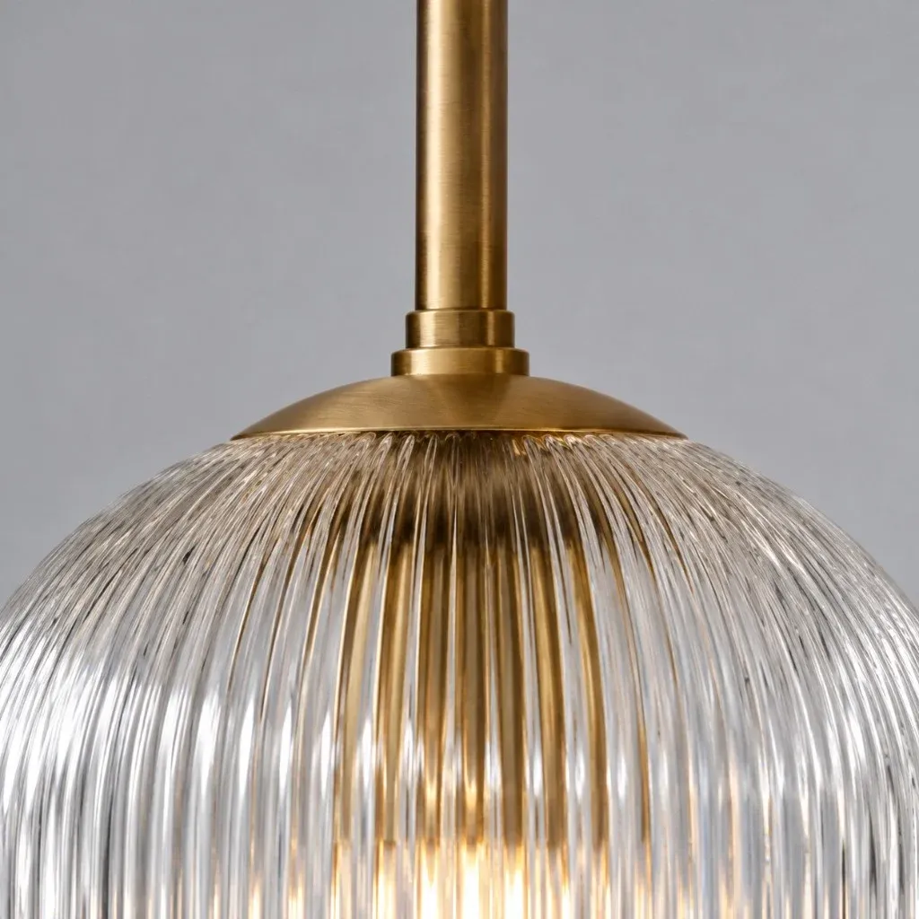 Brass rod and cap meeting the top of a ribbed glass globe