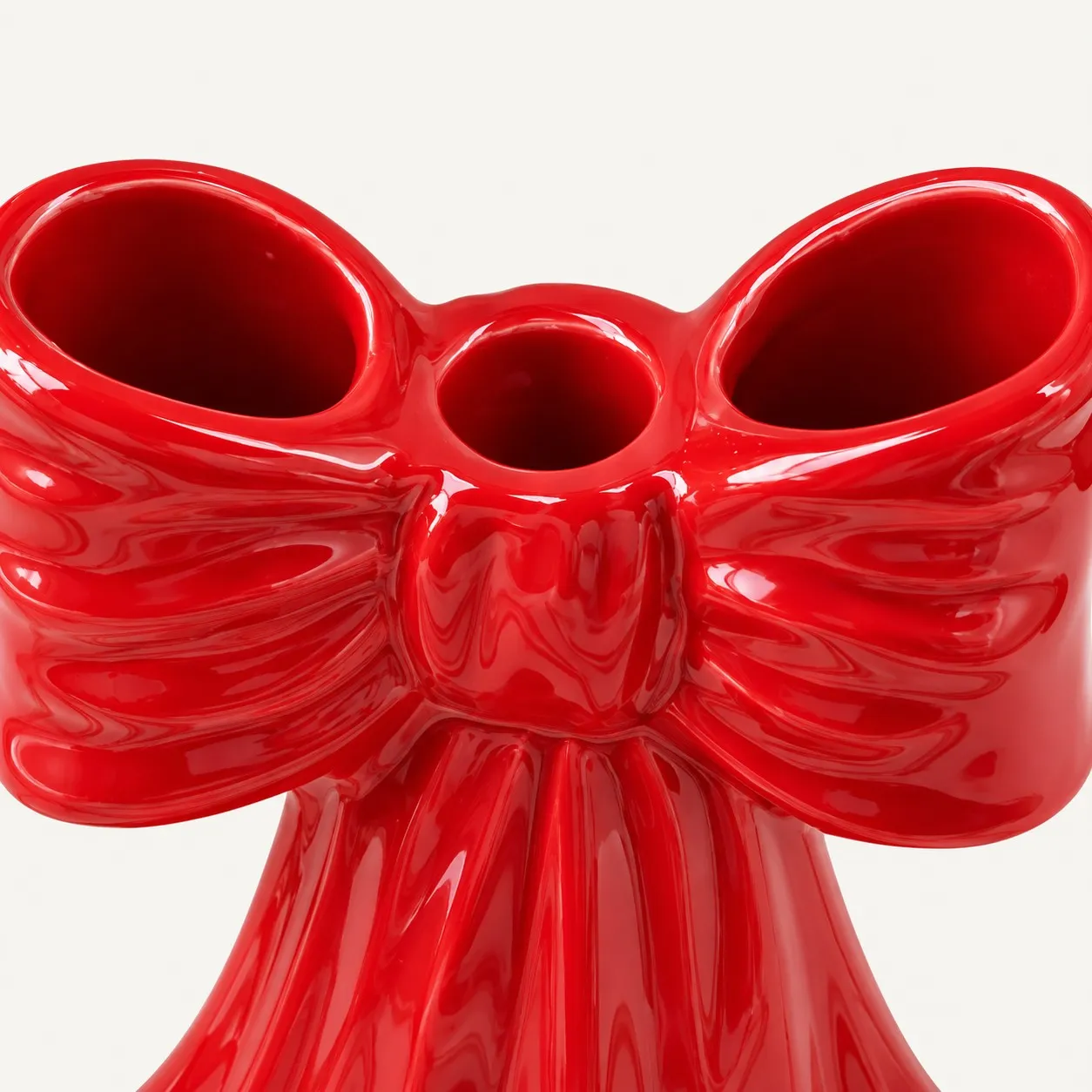 Bow knot detail of the red resin candle holder