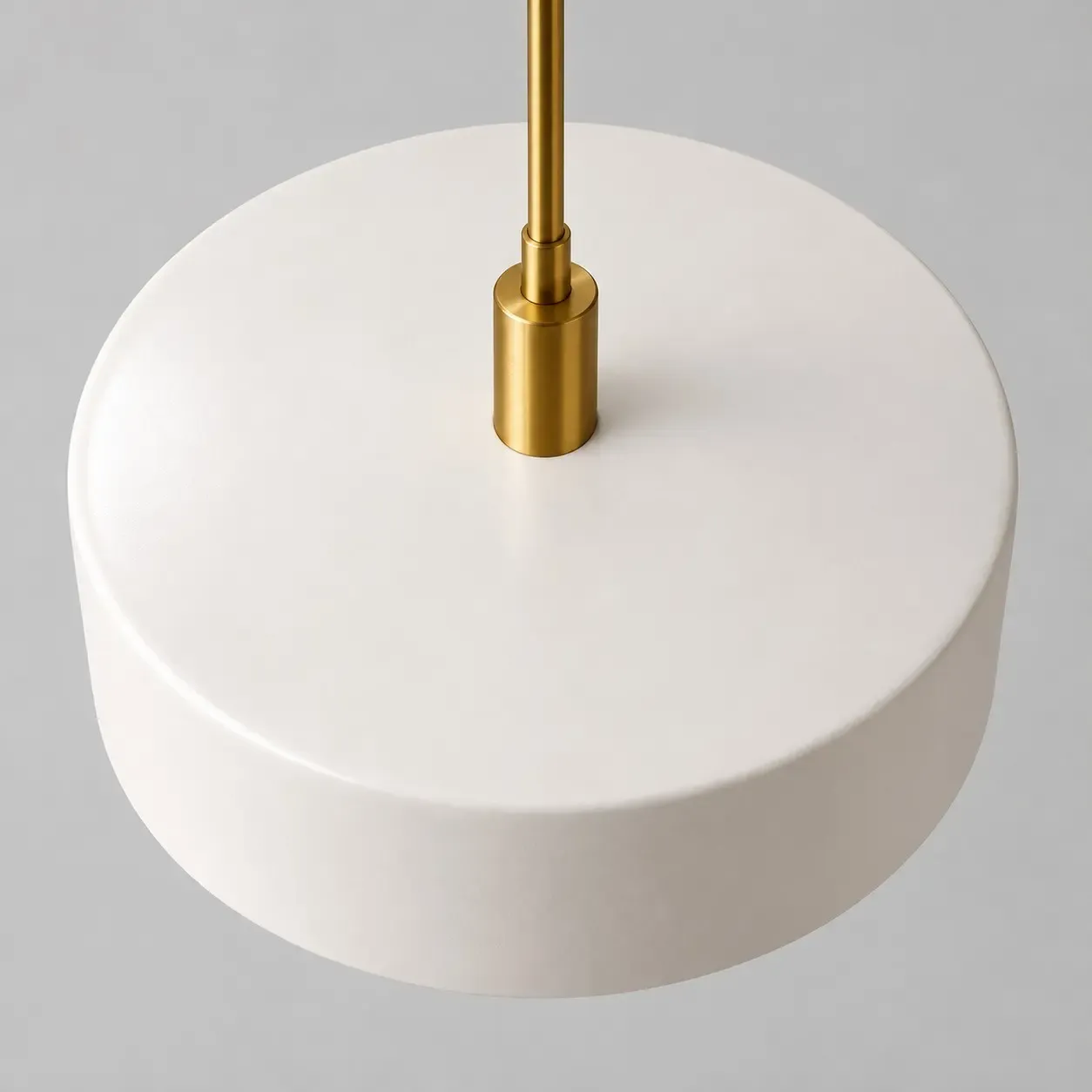 Looking down on the flat white porcelain top and the metal stem of the 14 inch drum