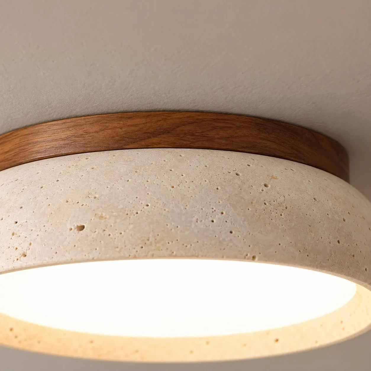 Walnut wood ring above a travertine bowl