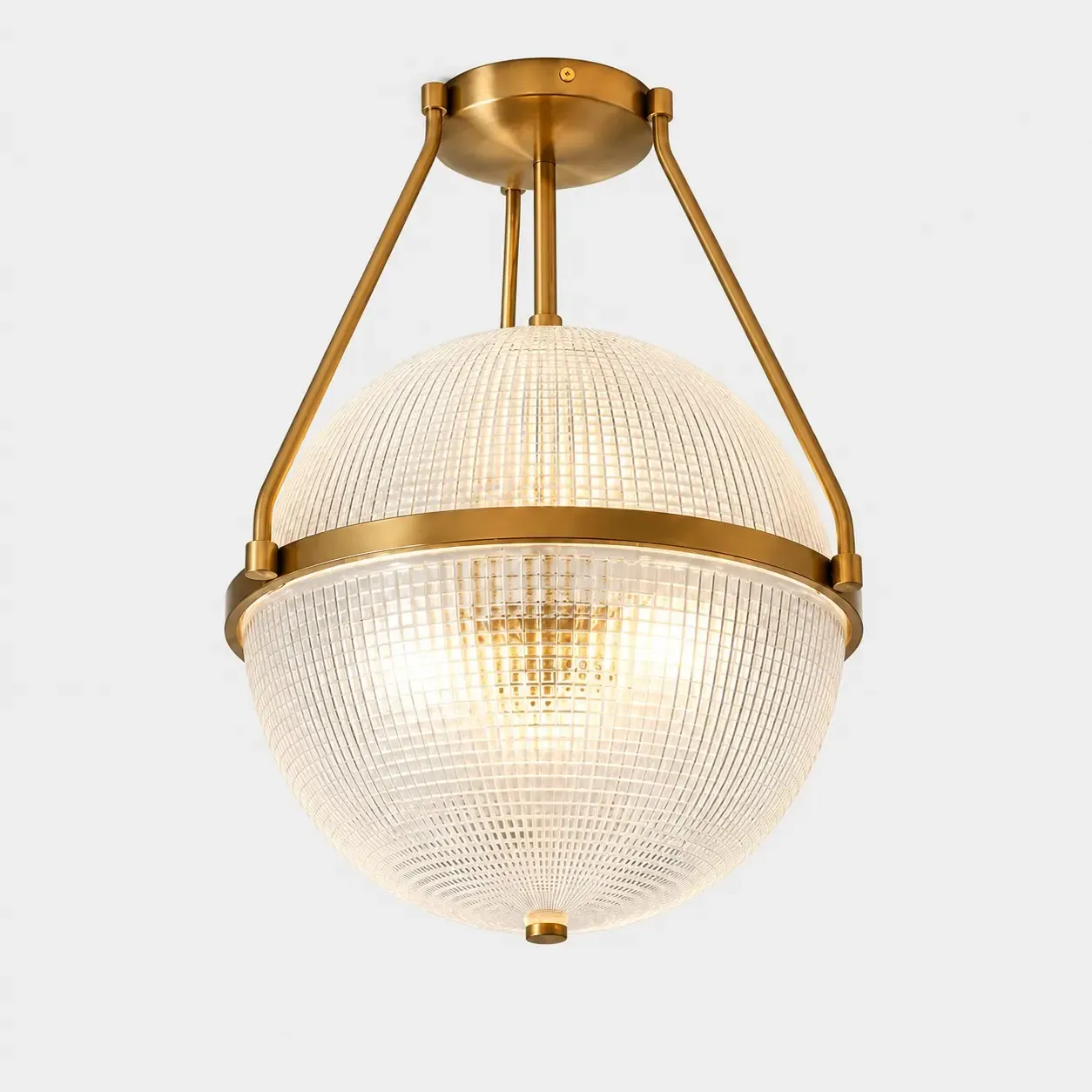 Gold glass globe semi-flush ceiling light on a light background, with bulbs fitted