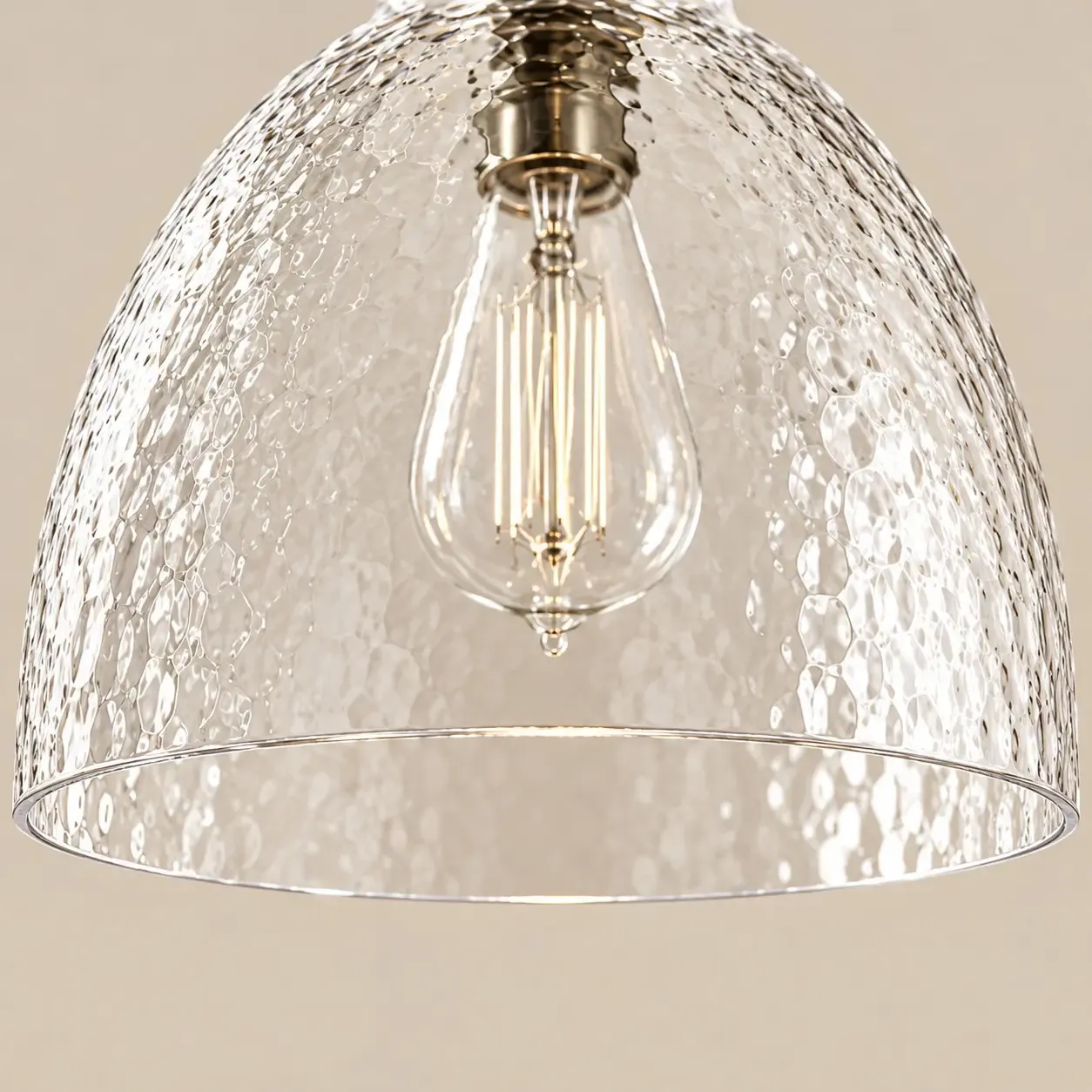 Looking up into the hammered glass bell at the open hem and the bulb