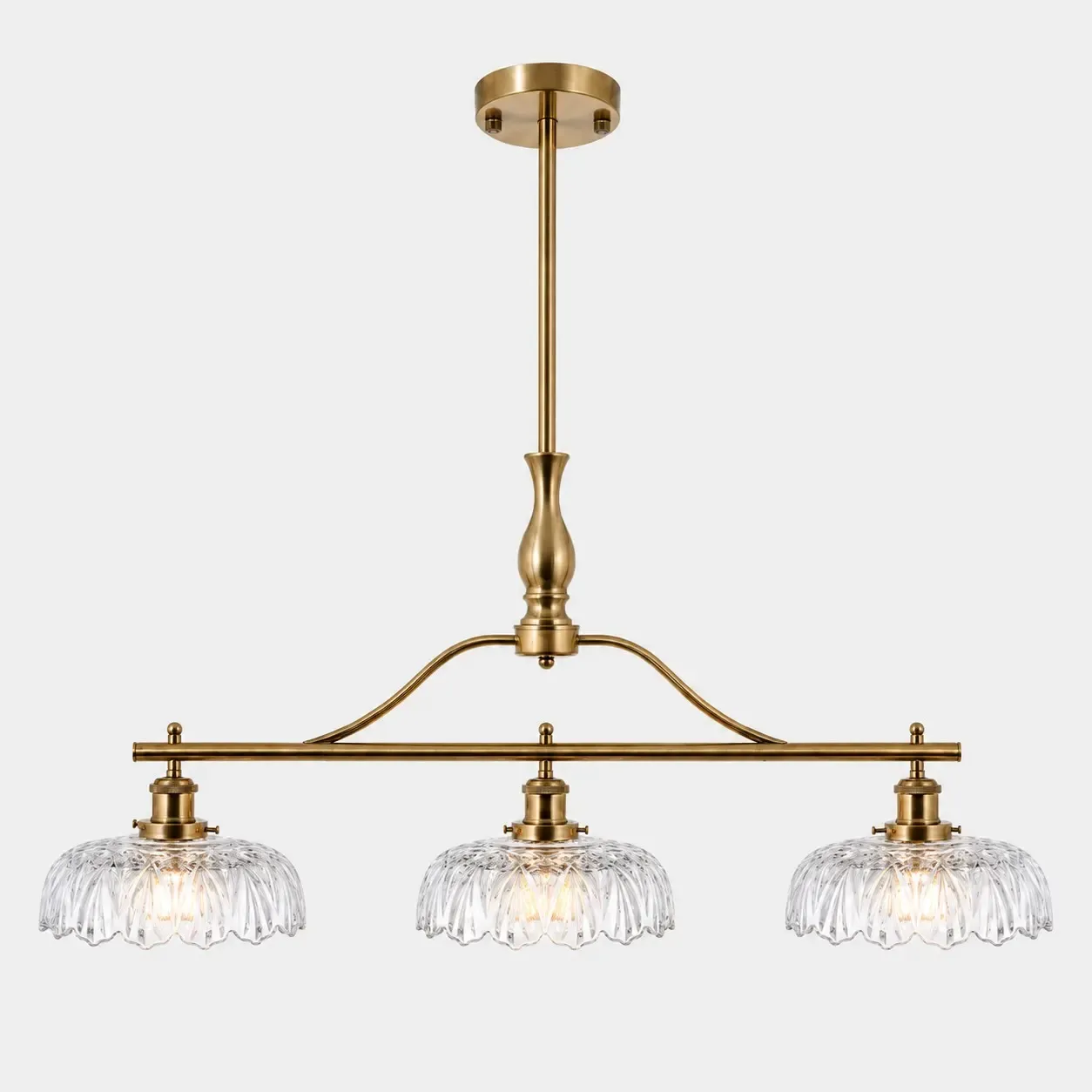 Brass Gold linear chandelier with three fluted glass shades and a round canopy