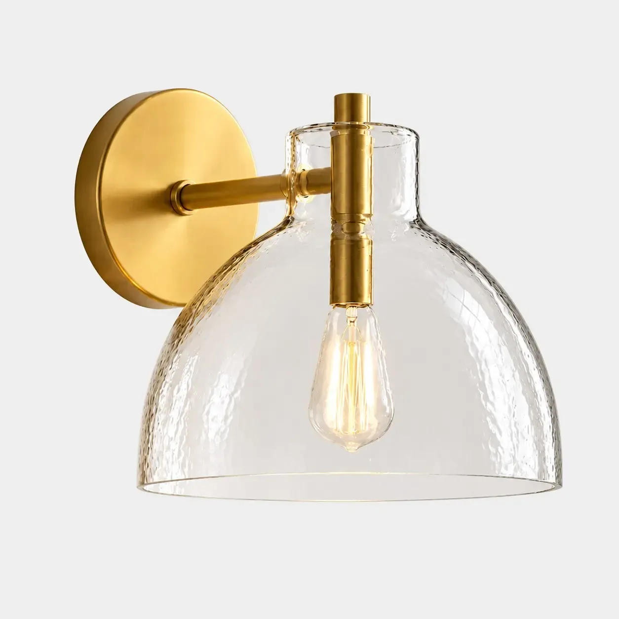 One hammered glass bell wall sconce in Brass