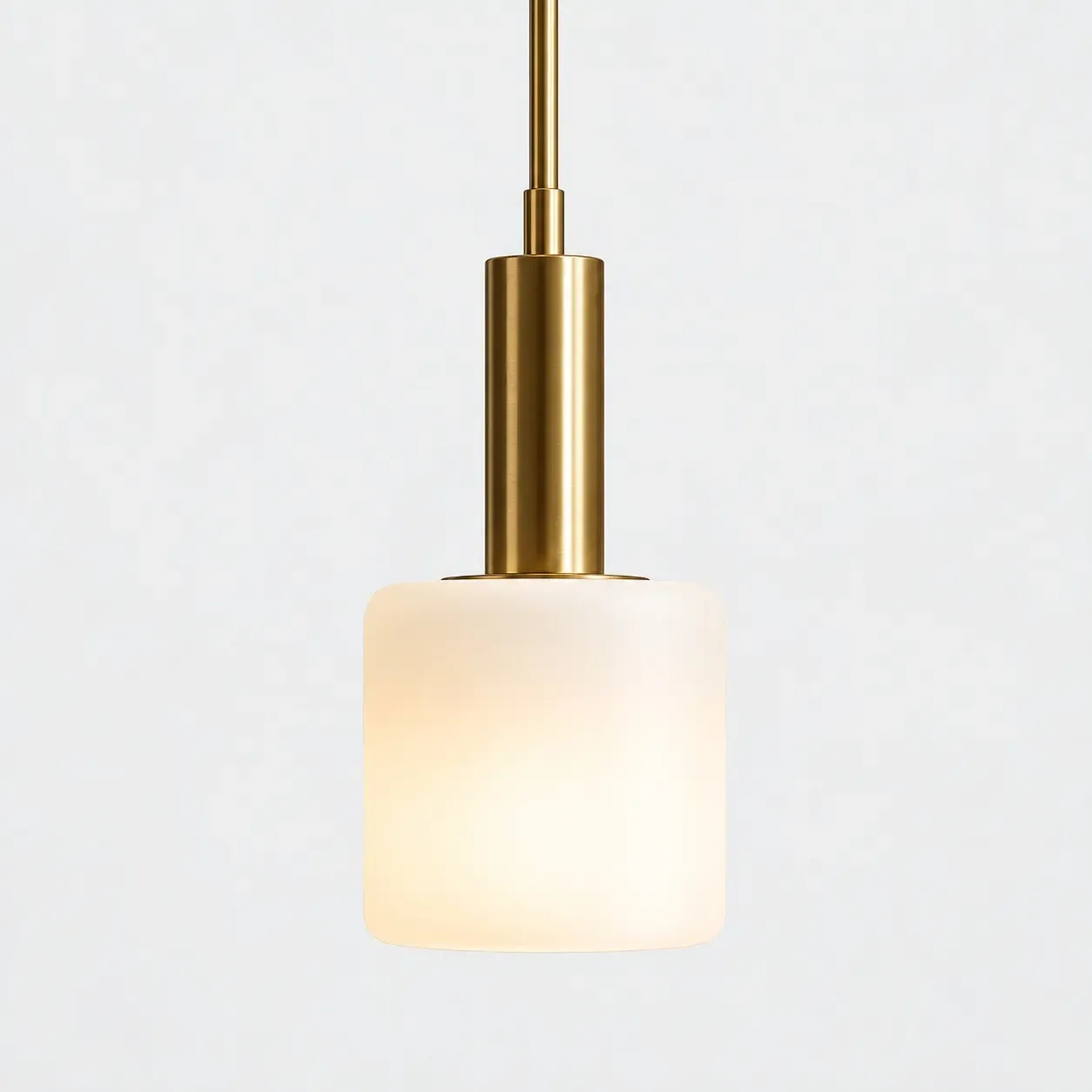5 inch white porcelain cylinder pendant with a metal rod, the shade glowing