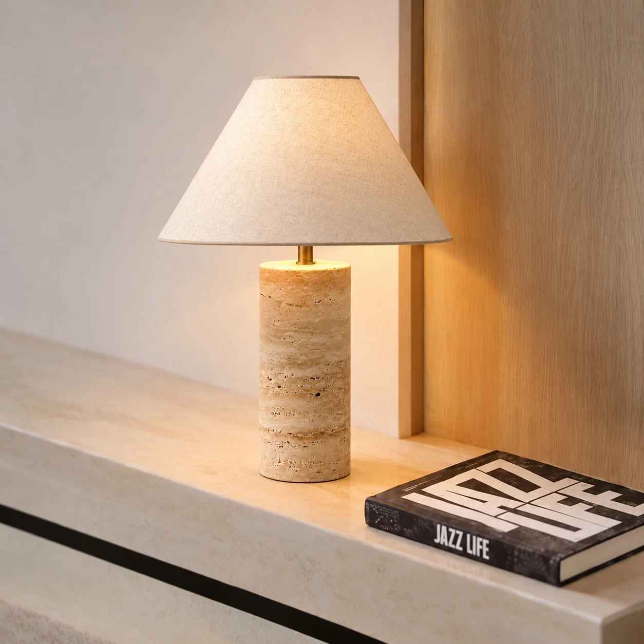 Cone Brass travertine table lamp on a stone mantel