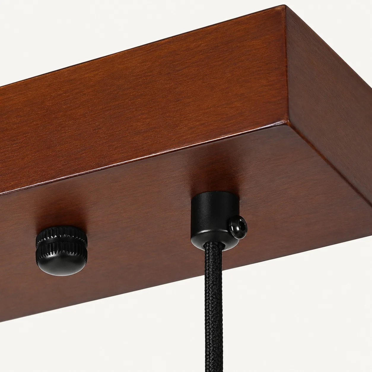 Walnut-toned wood canopy with black metal cord grip