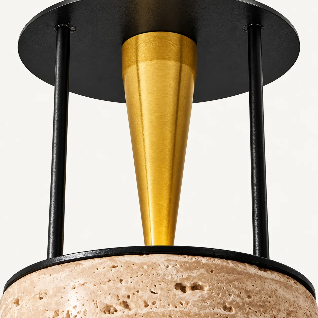 Brass-toned cone between black metal posts