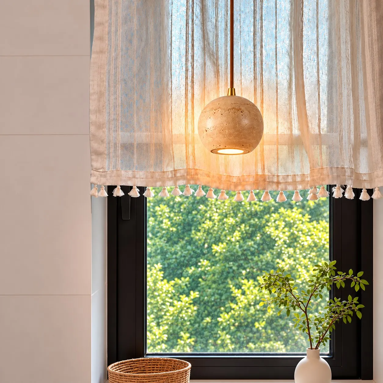 Short travertine cylinder pendant in a kitchen at dusk