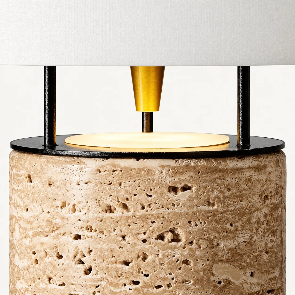 Natural pores in the travertine base with black posts and a brass cone